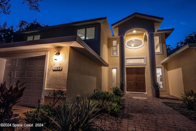 view of exterior entry at twilight