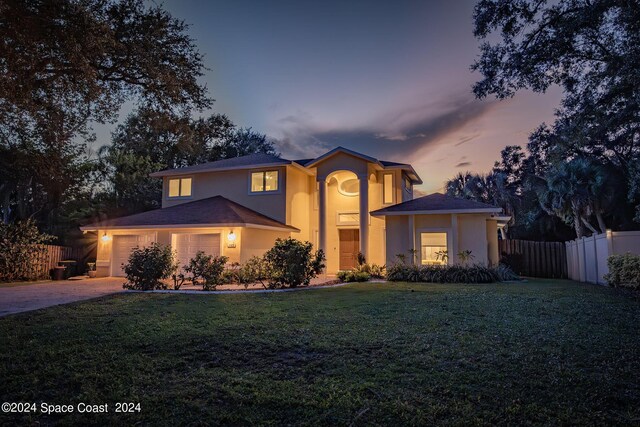 1165 Old Parsonage Dr, Merritt Island, FL 32952 - traditional-style house featuring an attached garage, stucco siding, and concrete driveway
