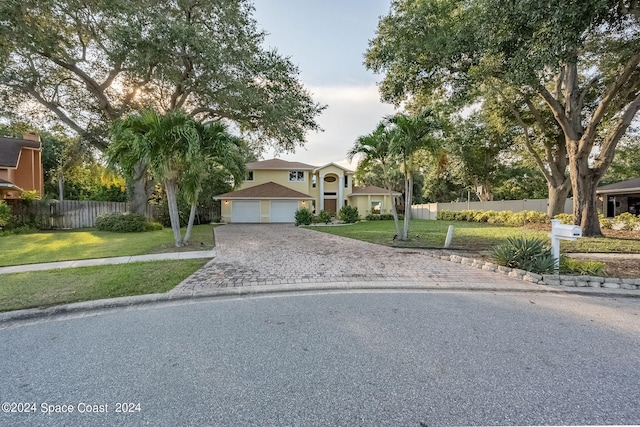 view of front of home featuring a garage and a front lawn