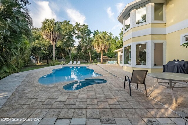 1165 Old Parsonage Dr, Merritt Island, FL 32952 - view of pool with a patio area, a pool with connected hot tub, fence, and a grill