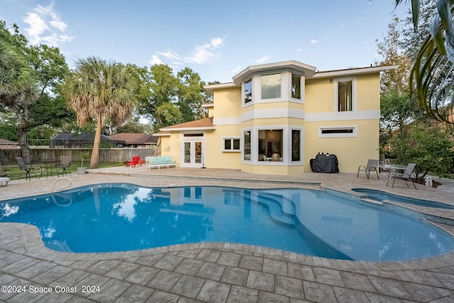 view of swimming pool featuring area for grilling and a patio area