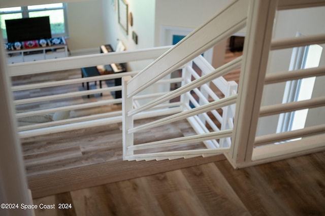 stairway with hardwood / wood-style floors