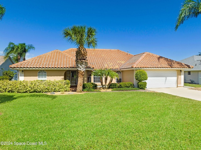 mediterranean / spanish-style house with a front yard and a garage