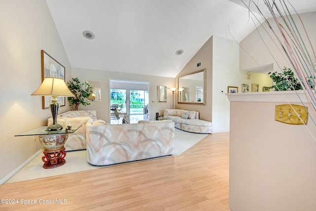 living room with hardwood / wood-style floors and vaulted ceiling