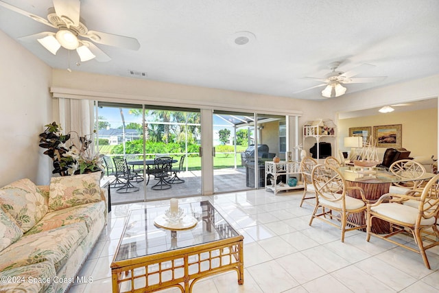 living room with ceiling fan and light tile patterned floors