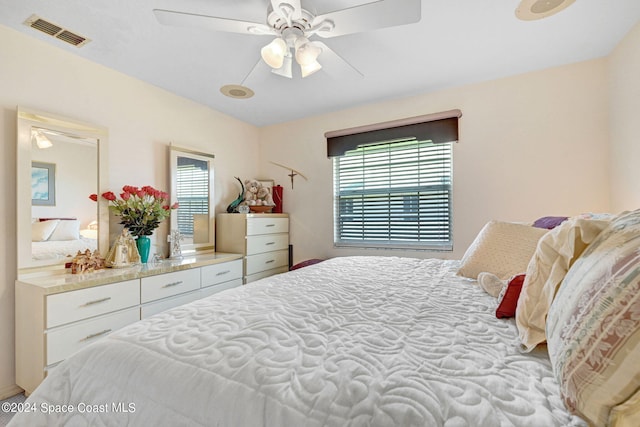 bedroom with multiple windows and ceiling fan