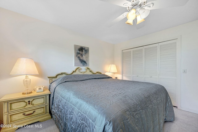 carpeted bedroom featuring a closet and ceiling fan