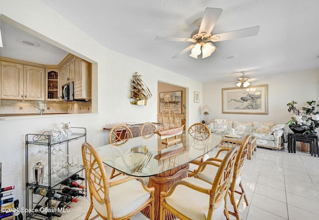 tiled dining area with ceiling fan