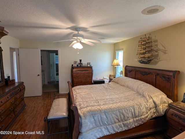 bedroom featuring a textured ceiling, dark hardwood / wood-style flooring, and ceiling fan