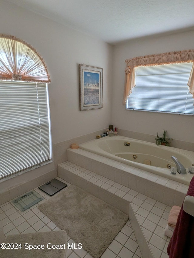 bathroom featuring a relaxing tiled tub and tile patterned floors