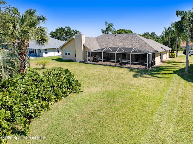 818 Spanish Wells Dr, Melbourne, FL 32940 - rear view of property featuring glass enclosure, a garage, a patio area, a lawn, and stucco siding