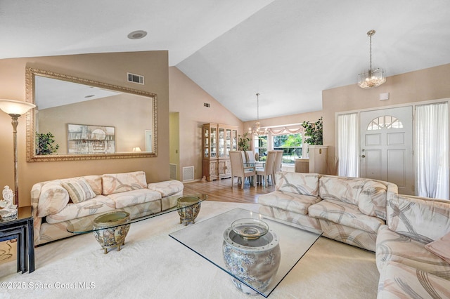 818 Spanish Wells Dr, Melbourne, FL 32940 - living room with visible vents, high vaulted ceiling, and a notable chandelier