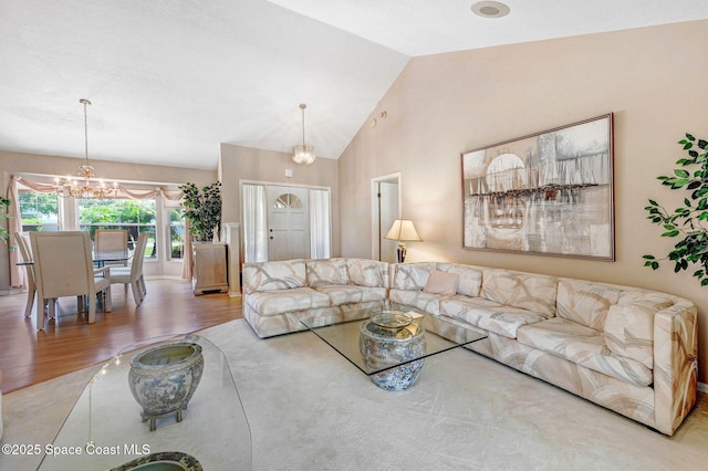 818 Spanish Wells Dr, Melbourne, FL 32940 - living room featuring wood finished floors, high vaulted ceiling, and a chandelier