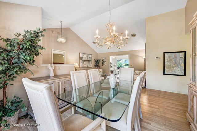 818 Spanish Wells Dr, Melbourne, FL 32940 - dining area with vaulted ceiling, light wood finished floors, baseboards, and a notable chandelier