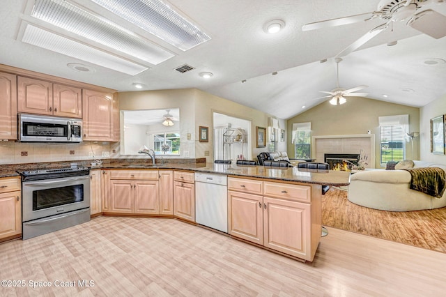 818 Spanish Wells Dr, Melbourne, FL 32940 - kitchen featuring visible vents, a sink, light wood-style floors, appliances with stainless steel finishes, and ceiling fan