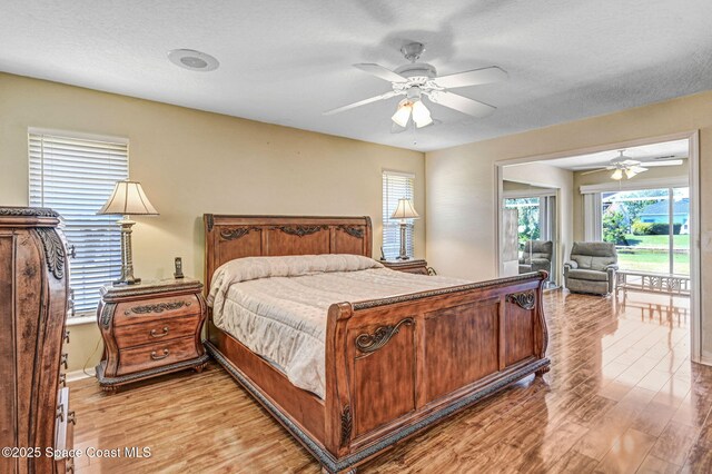 818 Spanish Wells Dr, Melbourne, FL 32940 - bedroom featuring baseboards, a ceiling fan, access to exterior, and light wood-style floors