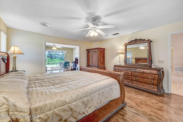 818 Spanish Wells Dr, Melbourne, FL 32940 - bedroom with light wood-style floors, visible vents, a ceiling fan, and a textured ceiling