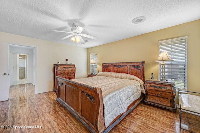 818 Spanish Wells Dr, Melbourne, FL 32940 - bedroom featuring light wood-type flooring, a textured ceiling, and multiple windows