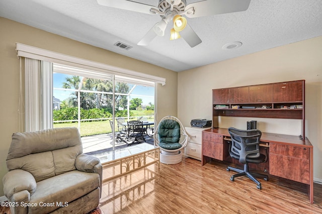 818 Spanish Wells Dr, Melbourne, FL 32940 - office space featuring ceiling fan, light wood finished floors, a textured ceiling, and visible vents