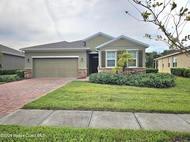 view of front of property with a front yard and a garage