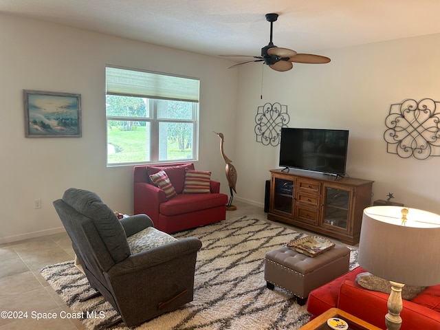 living room featuring ceiling fan and light tile patterned floors