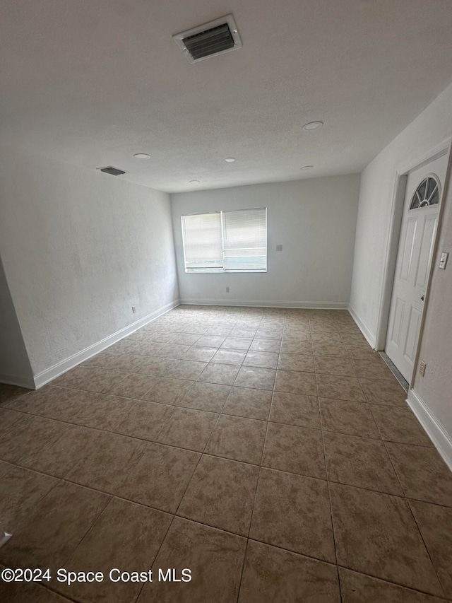 empty room with tile patterned floors