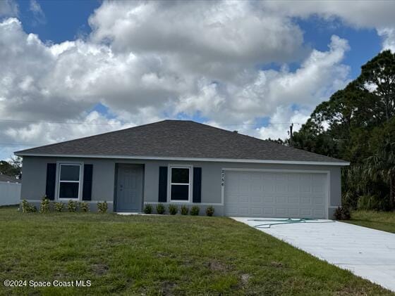 ranch-style home featuring a front yard and a garage