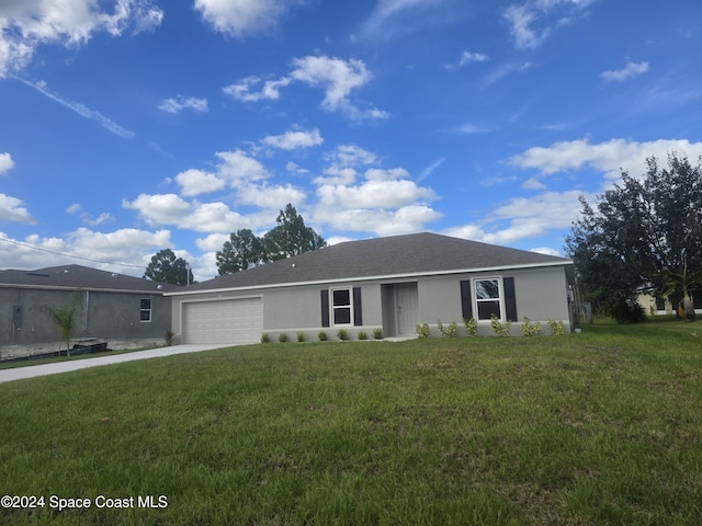 427 Fountain St SW, Palm Bay, FL 32908 - single story home with stucco siding, a garage, a front lawn, and driveway