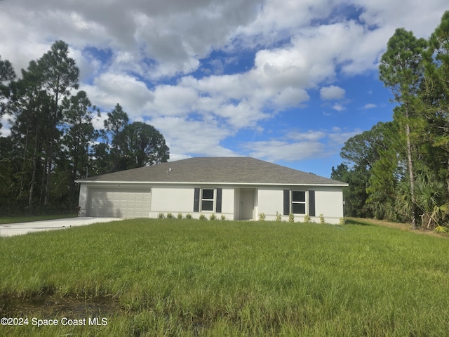 ranch-style home with stucco siding, an attached garage, driveway, and a front lawn