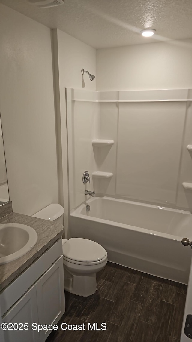 295 Crescent St SE, Palm Bay, FL 32909 - bathroom with vanity, a textured ceiling, wood finished floors, and shower / tub combination