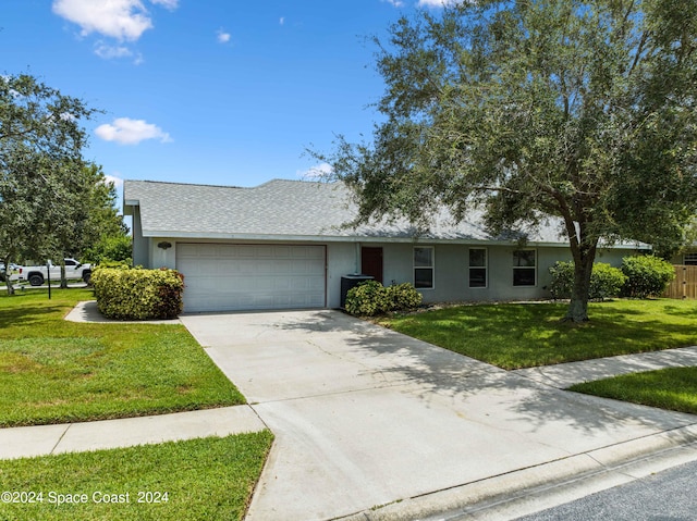 ranch-style house featuring a garage and a front lawn