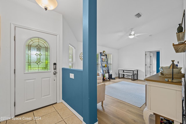 foyer with light hardwood / wood-style flooring, lofted ceiling, and ceiling fan