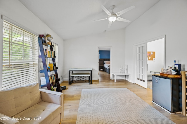 sitting room with wood-type flooring, vaulted ceiling, french doors, and ceiling fan