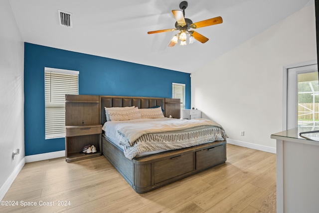 bedroom with lofted ceiling, light hardwood / wood-style floors, and ceiling fan