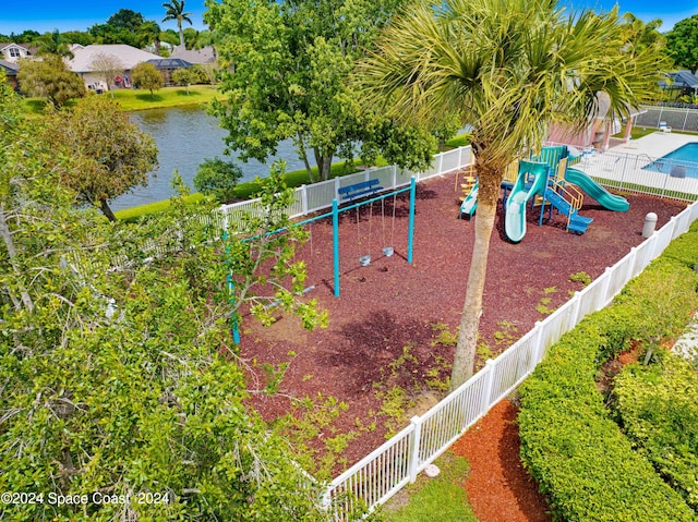 exterior space with a playground and a water view