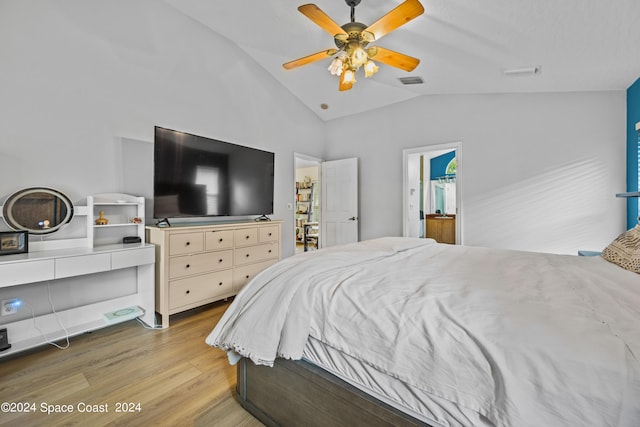 bedroom with ceiling fan, light hardwood / wood-style flooring, and vaulted ceiling