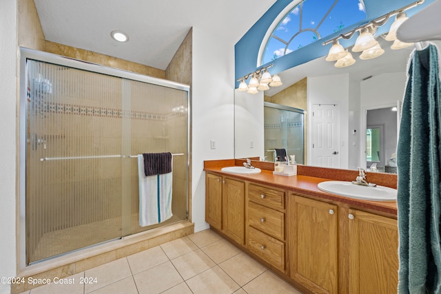 bathroom featuring tile patterned flooring, an enclosed shower, and vanity