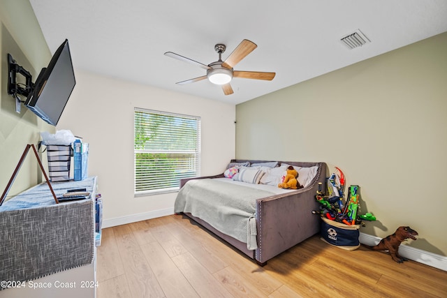 bedroom with ceiling fan and light wood-type flooring