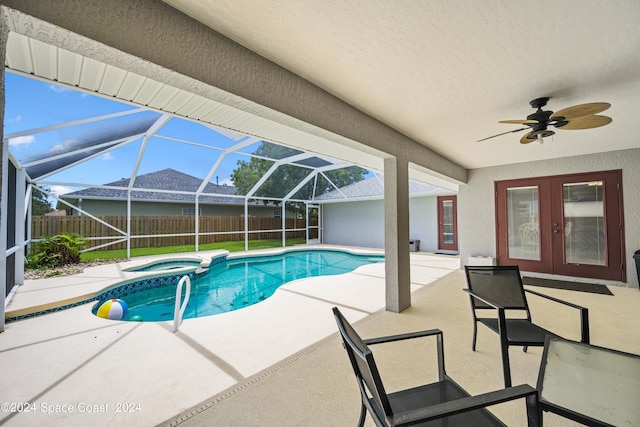 view of pool with a patio area, an in ground hot tub, glass enclosure, ceiling fan, and french doors