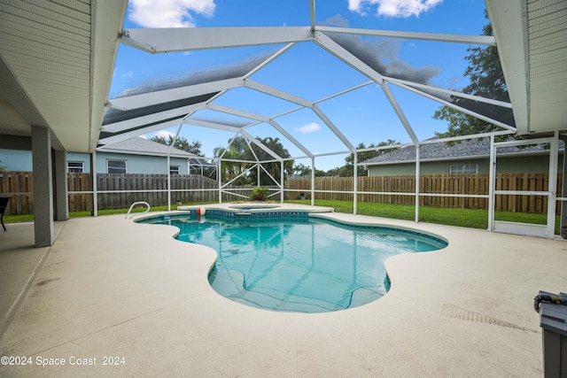 view of swimming pool with a lanai, a patio, and an in ground hot tub