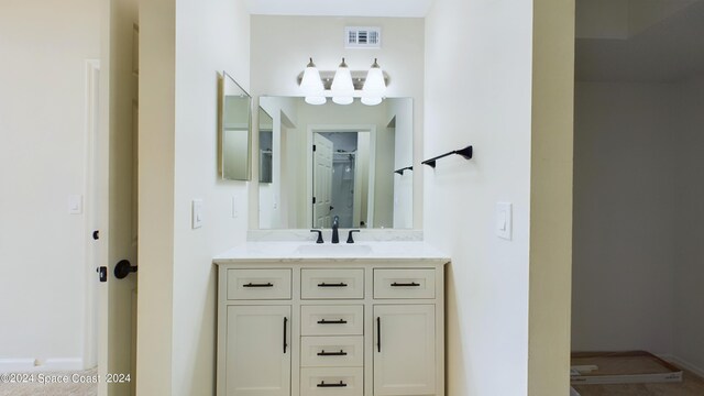 bathroom with vanity and a shower with door