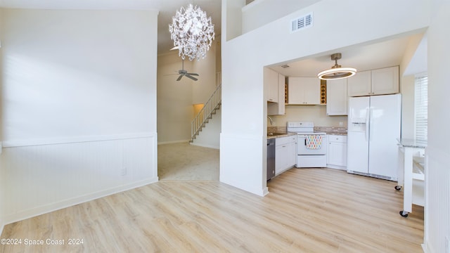 kitchen with white appliances, white cabinetry, light hardwood / wood-style floors, ceiling fan, and decorative light fixtures