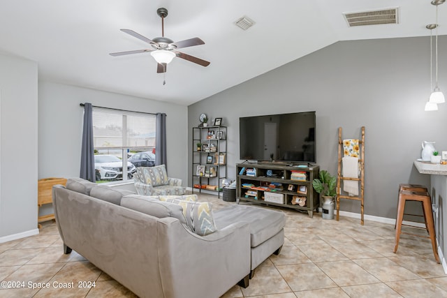 living room with ceiling fan, vaulted ceiling, and light tile patterned floors