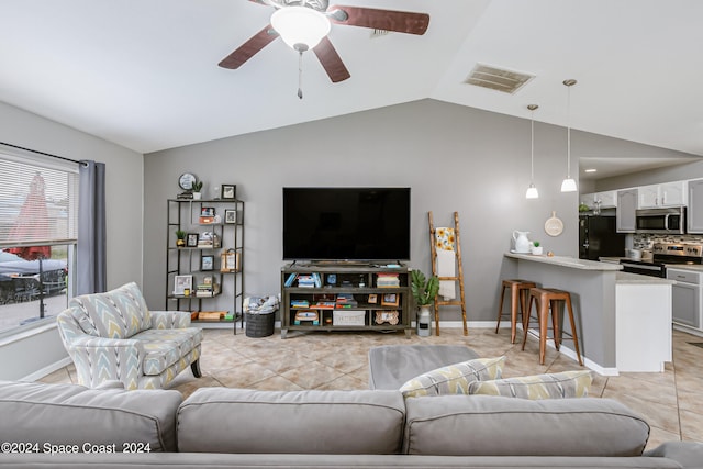 tiled living room featuring lofted ceiling and ceiling fan