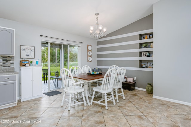 dining space featuring vaulted ceiling, a notable chandelier, and light tile patterned floors