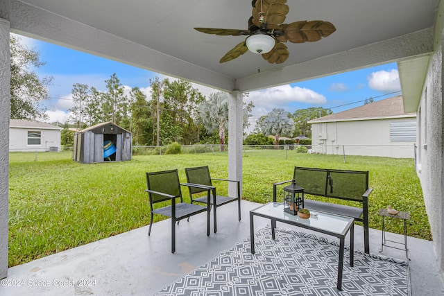 view of patio featuring ceiling fan and a storage unit