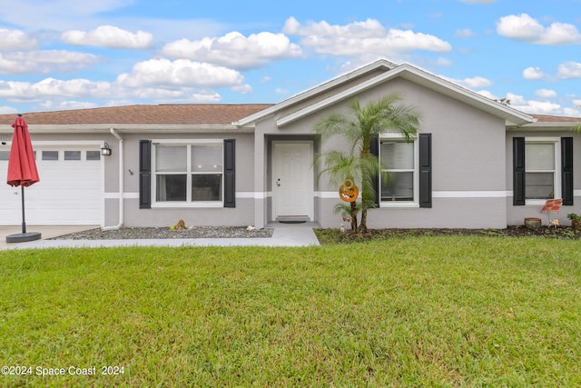 single story home with a front yard and a garage