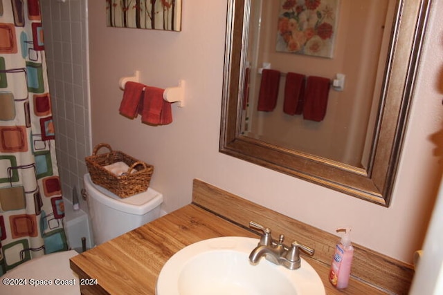 bathroom with vanity, toilet, and a shower with curtain