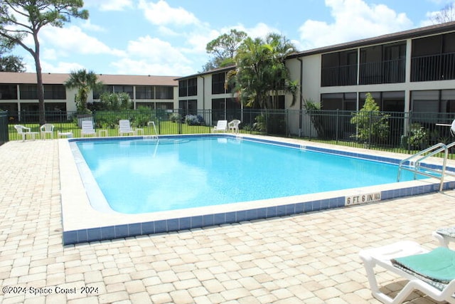 view of swimming pool featuring a patio area