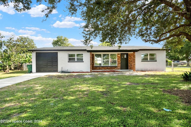 single story home with a garage and a front lawn